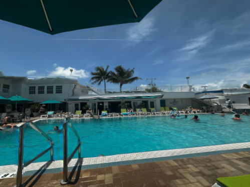 Resort pool with lounge chairs and palm trees