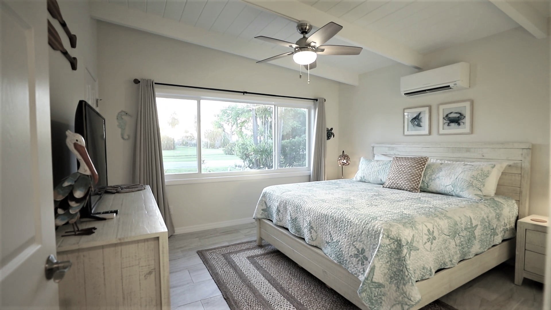 Bright coastal master bedroom with king bed
