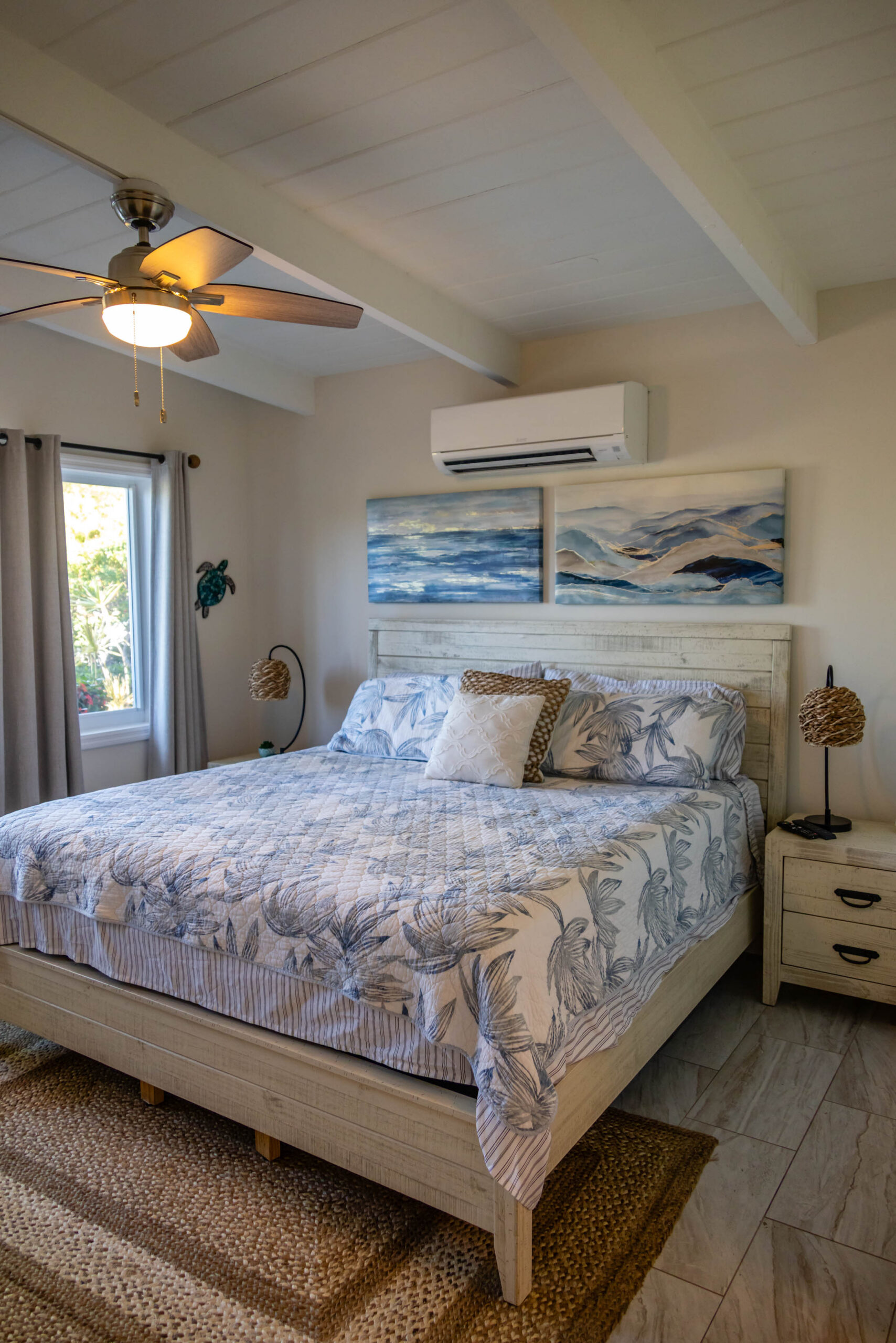 Coastal king bedroom with ocean wall art