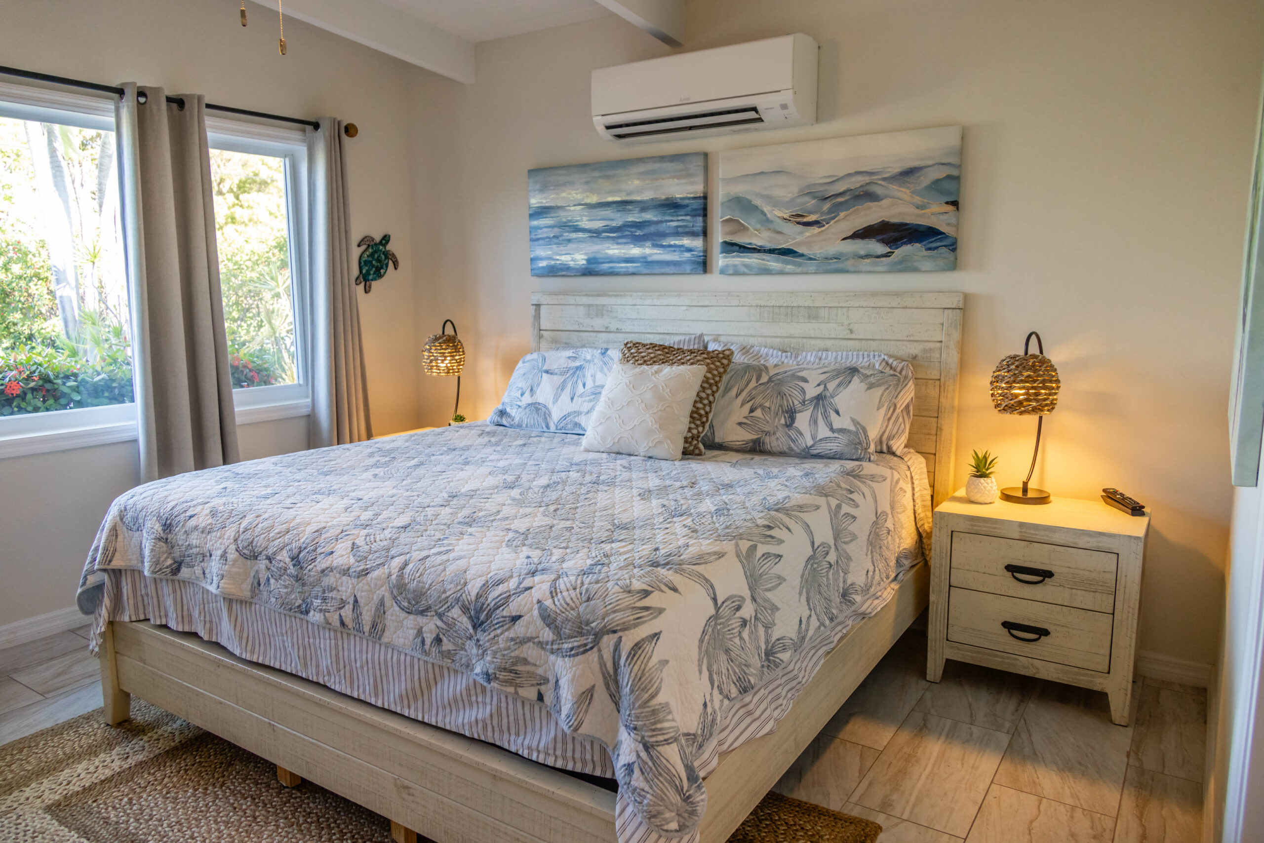 Coastal bedroom with patterned bedding and lamps
