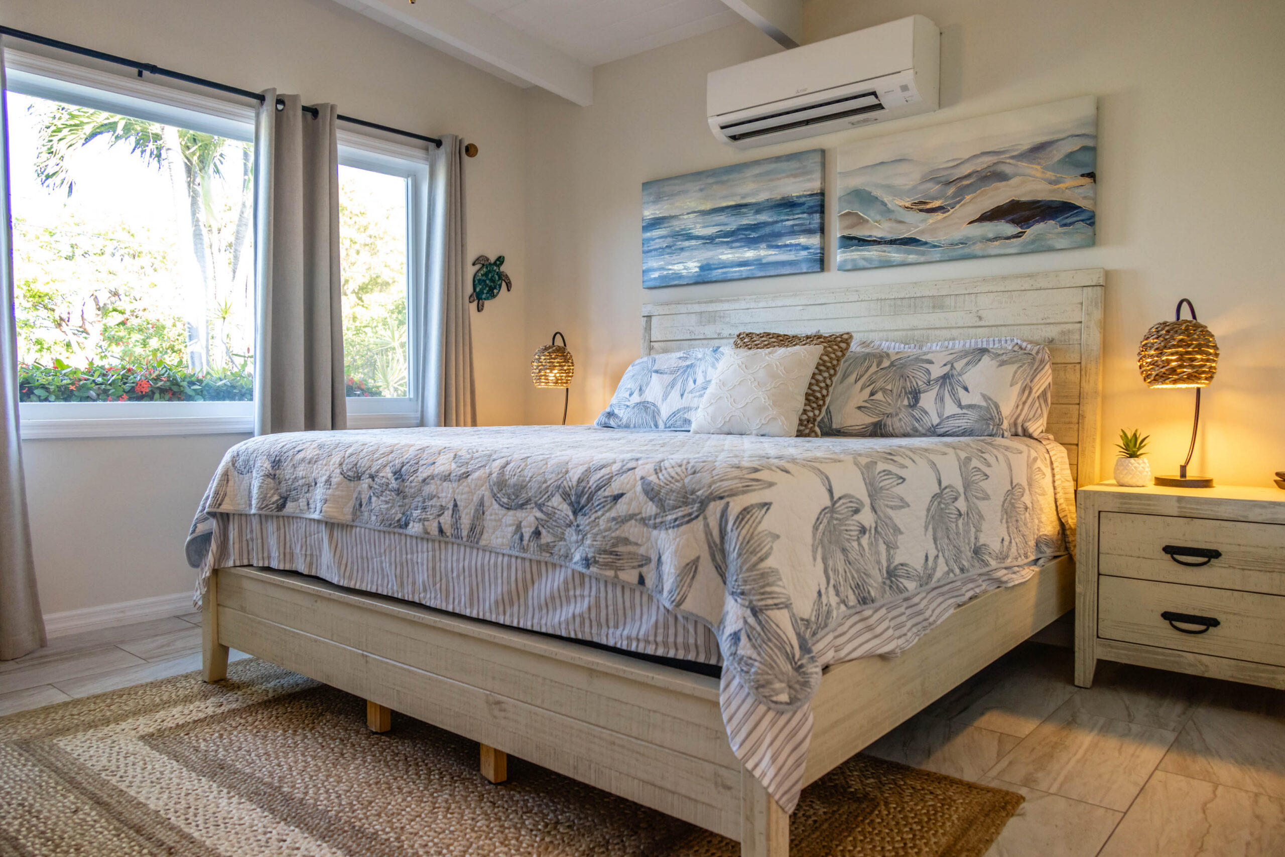 Coastal bedroom with king bed and artwork