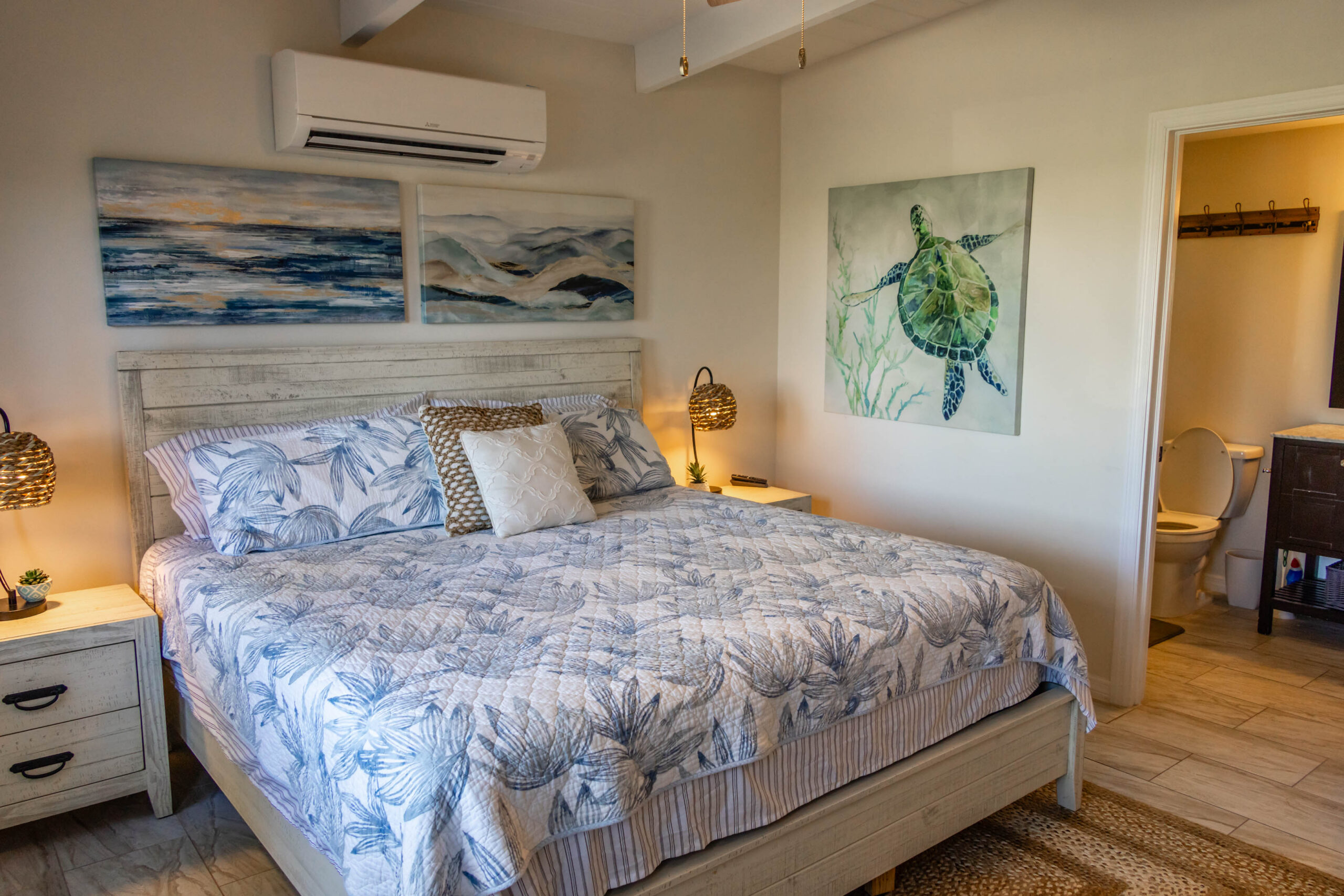 Coastal bedroom with king-sized bed, turtle art