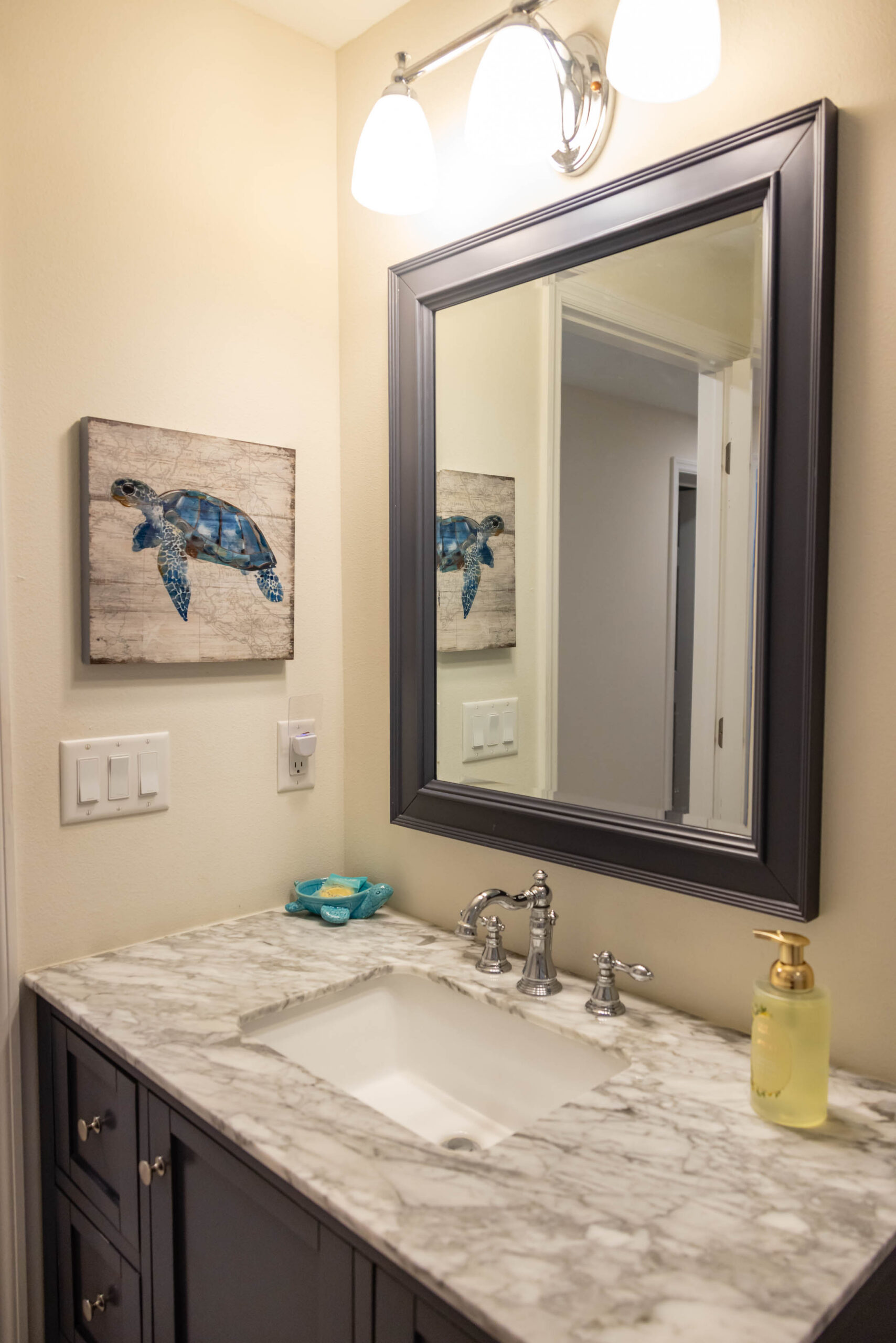 Marble bathroom vanity with turtle wall art