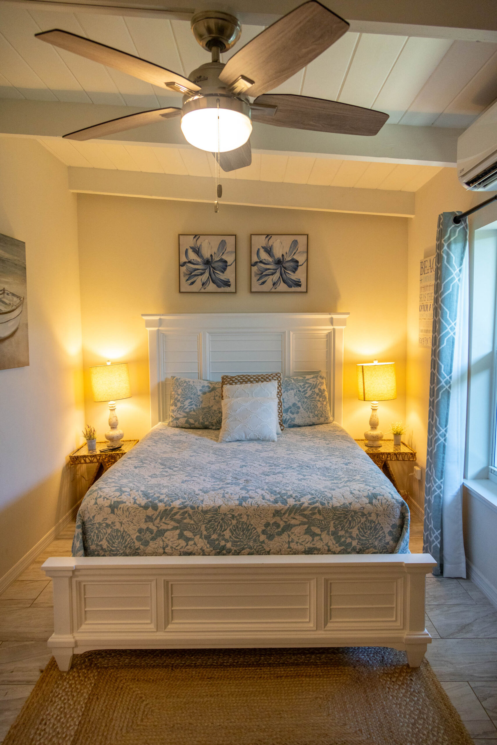 Cozy bedroom with white bed and ceiling fan