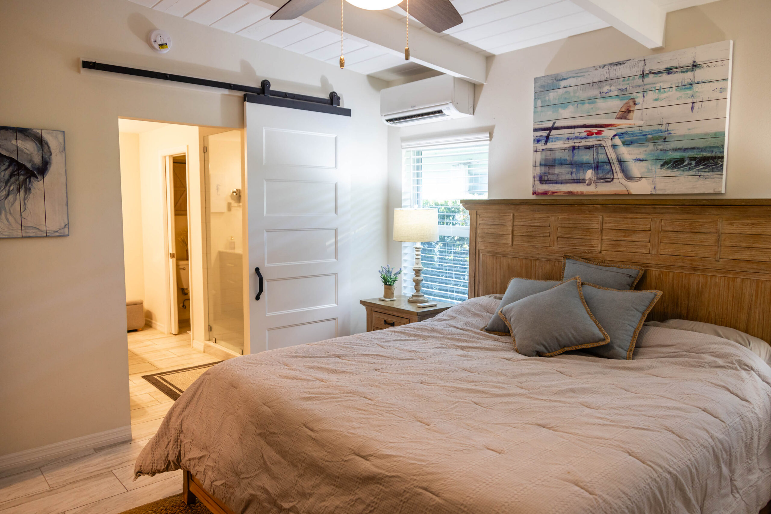 Cozy bedroom with wooden headboard and barn door