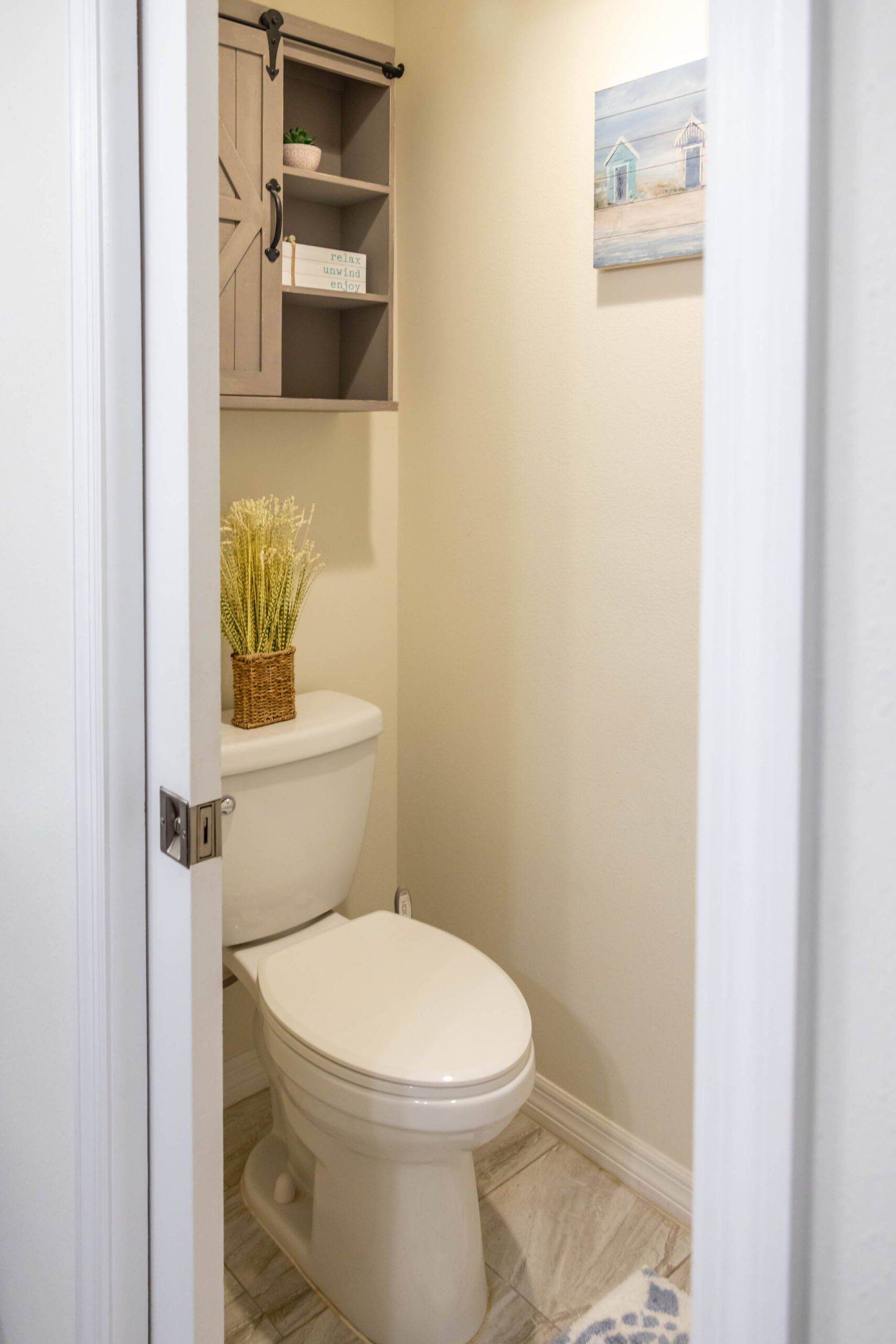 Small bathroom with toilet and wall shelves