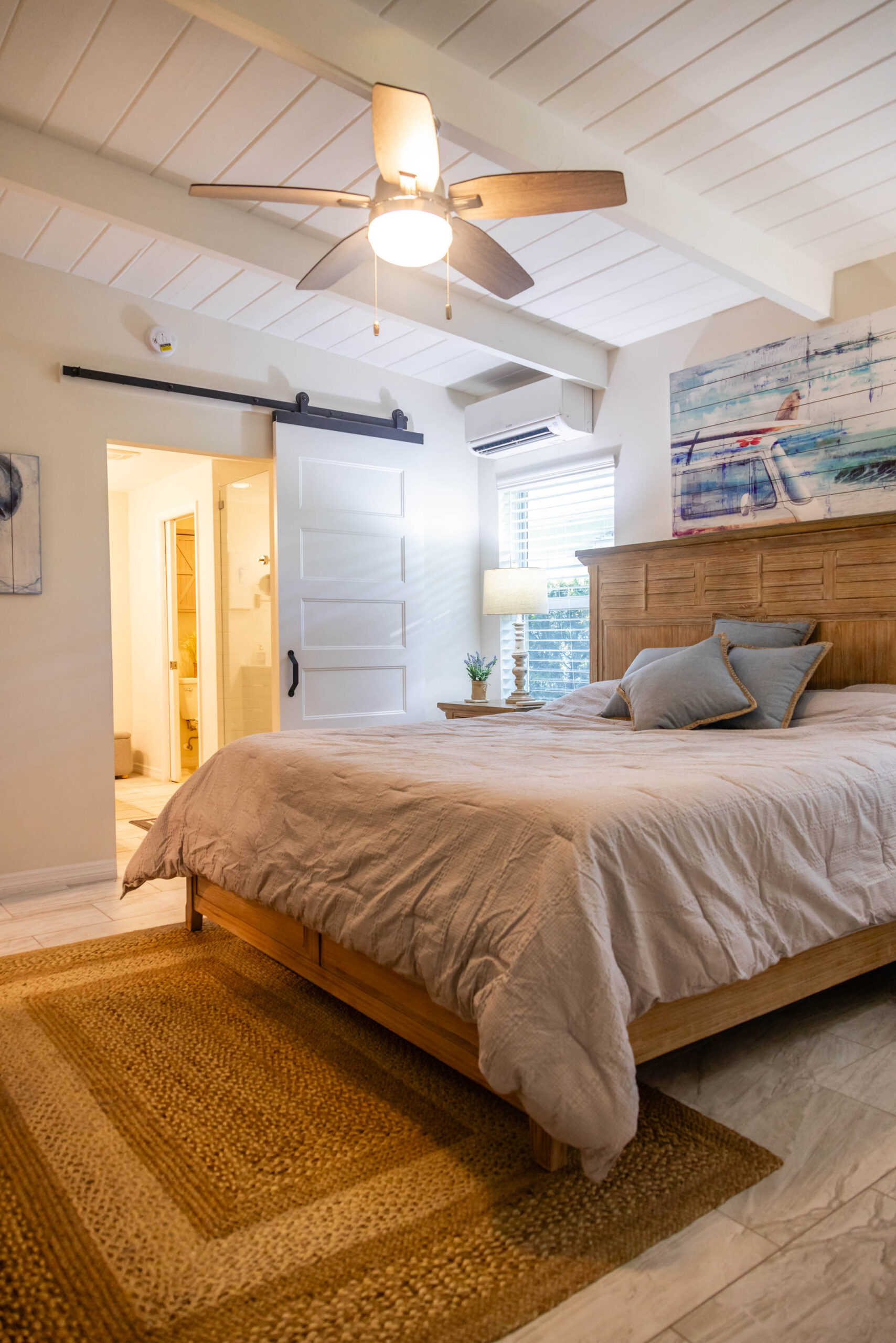 Cozy bedroom with wooden bed and ceiling fan