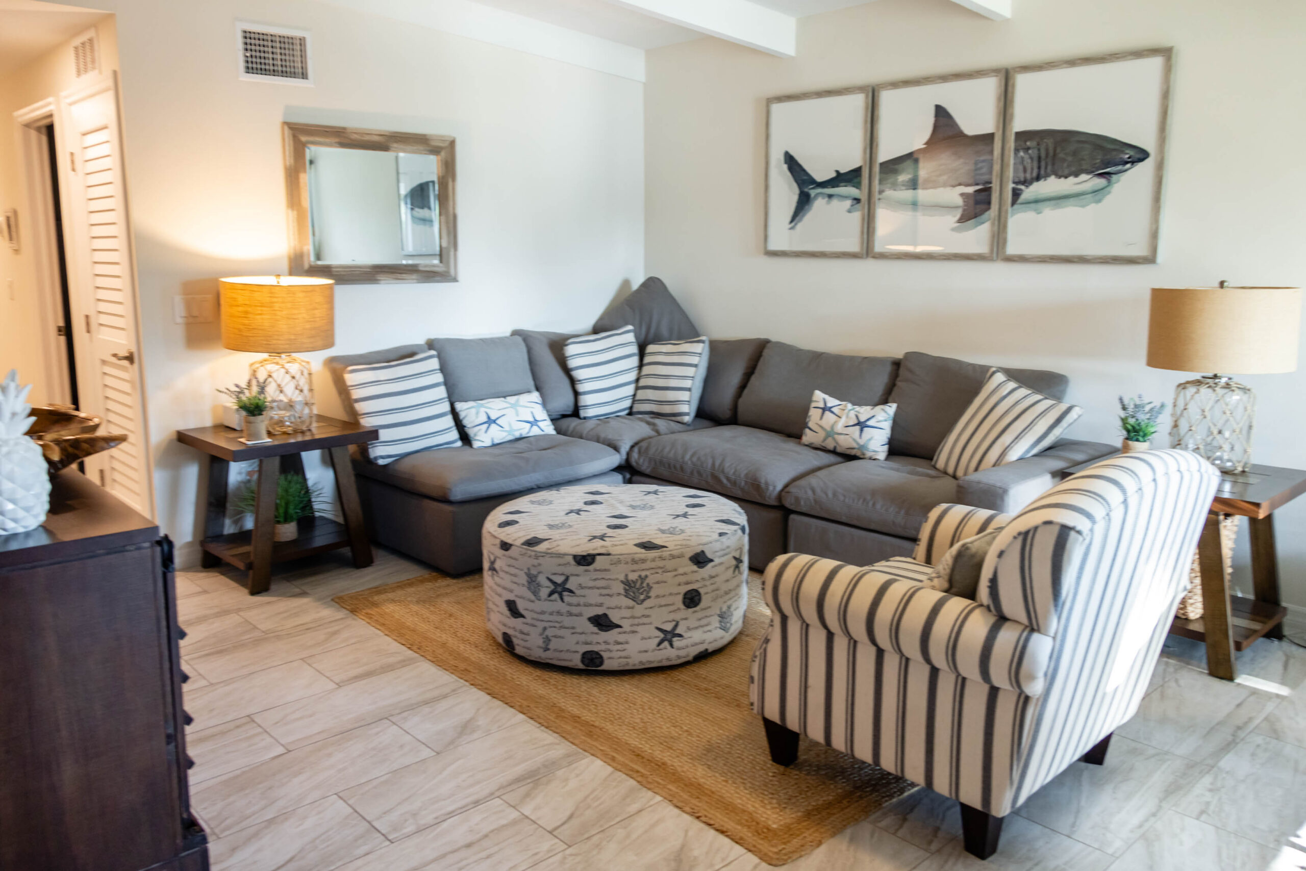 Shark artwork in coastal living room with sofa