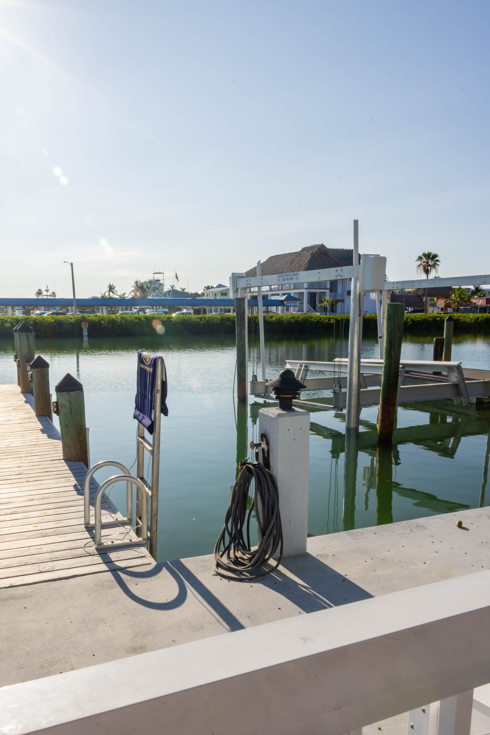 Sunny marina dock with boat lift
