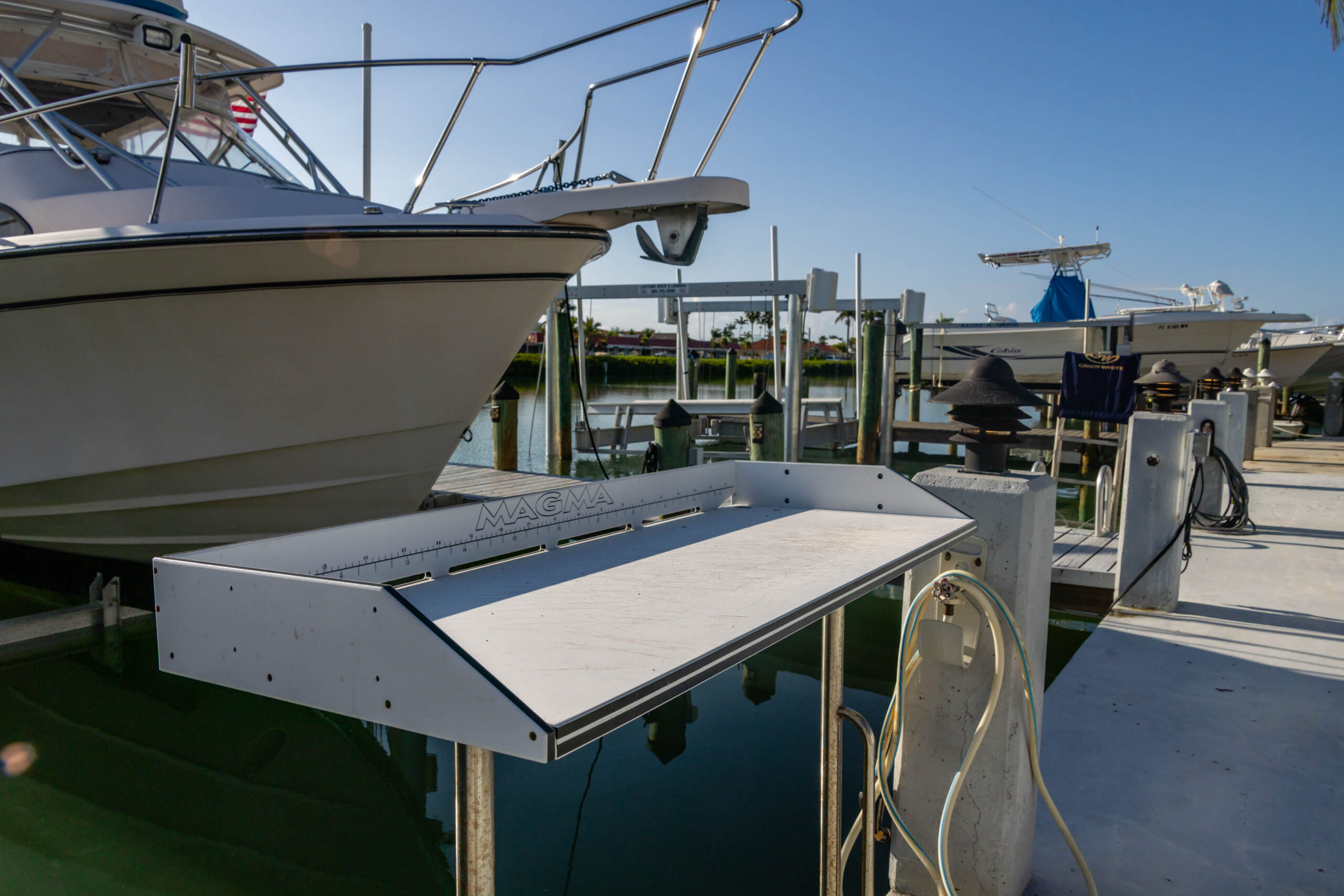 White boat on lift at marina dock