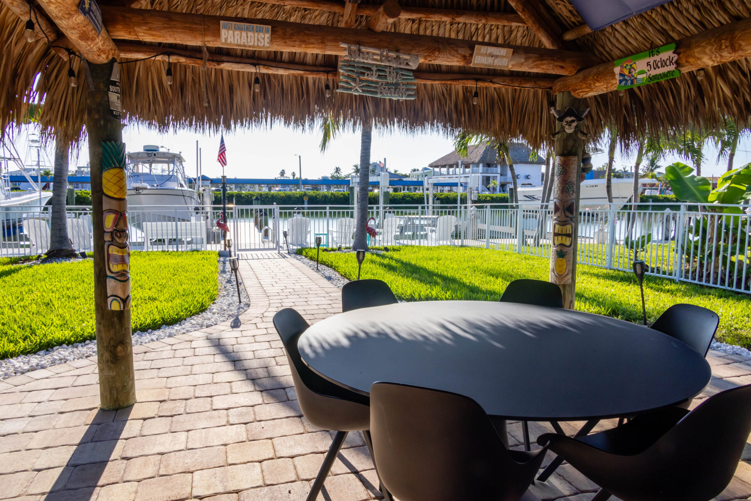Tiki hut seating area overlooking marina and boats