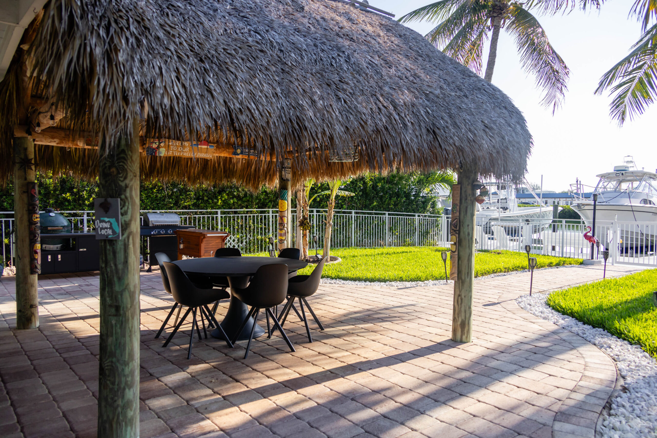 Thatched tiki hut patio with table and chairs