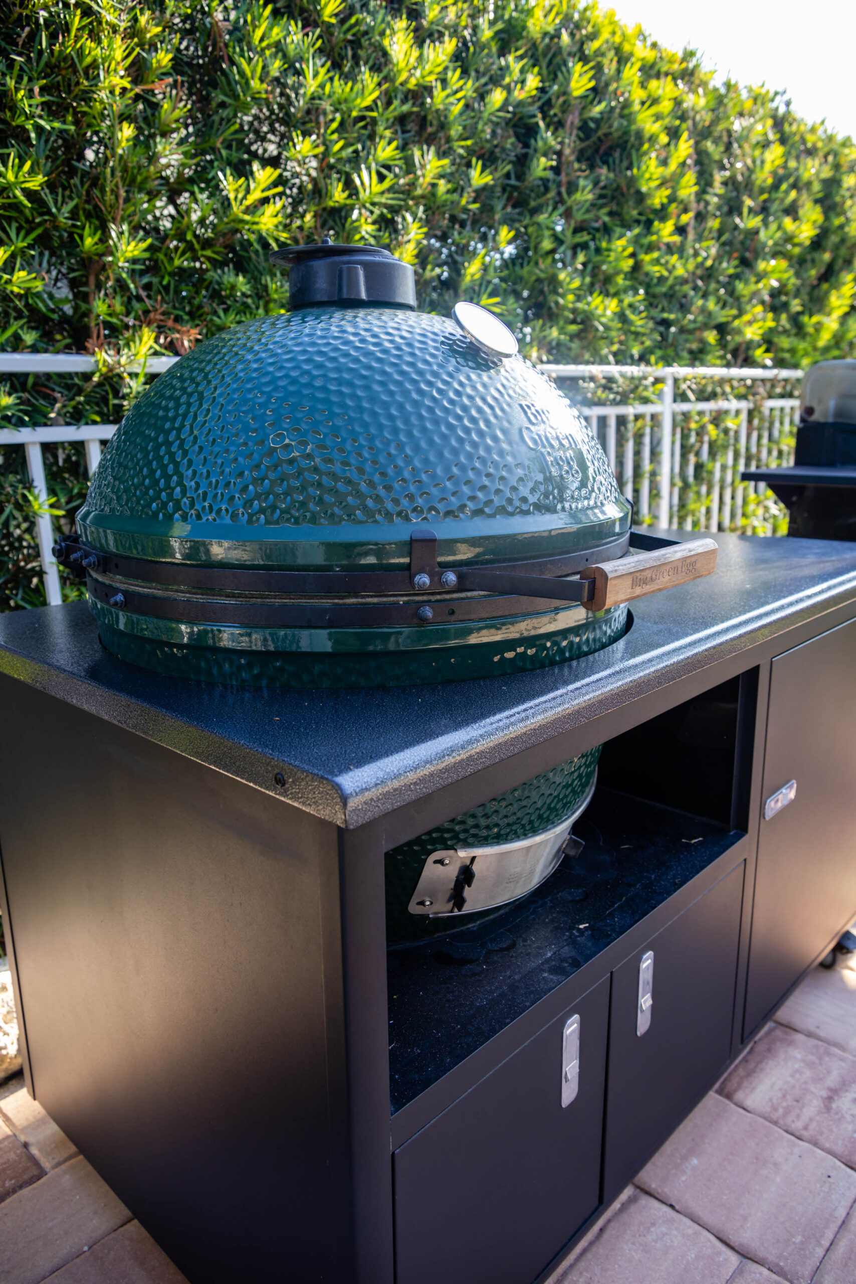 Green ceramic kamado grill on patio countertop