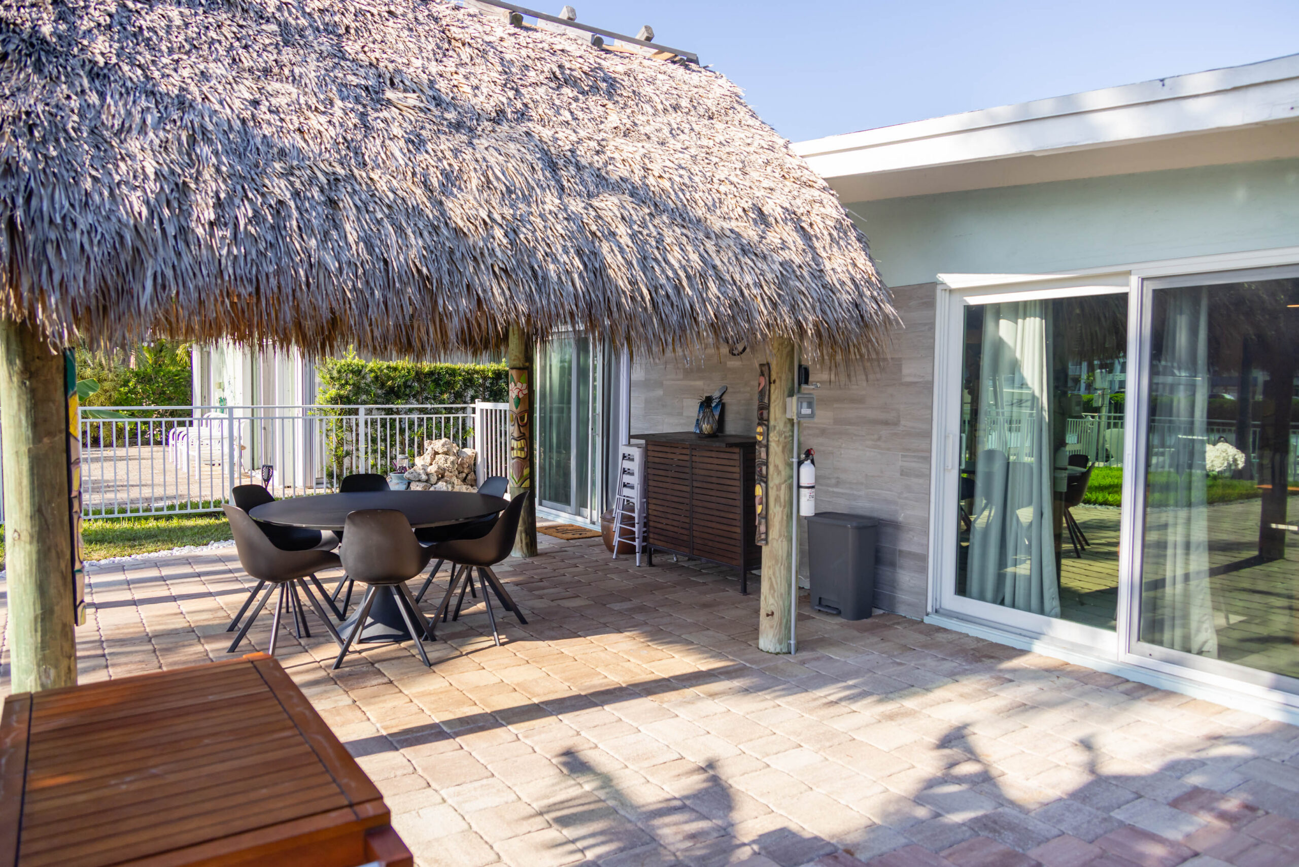 Backyard patio with thatched palapa and dining set