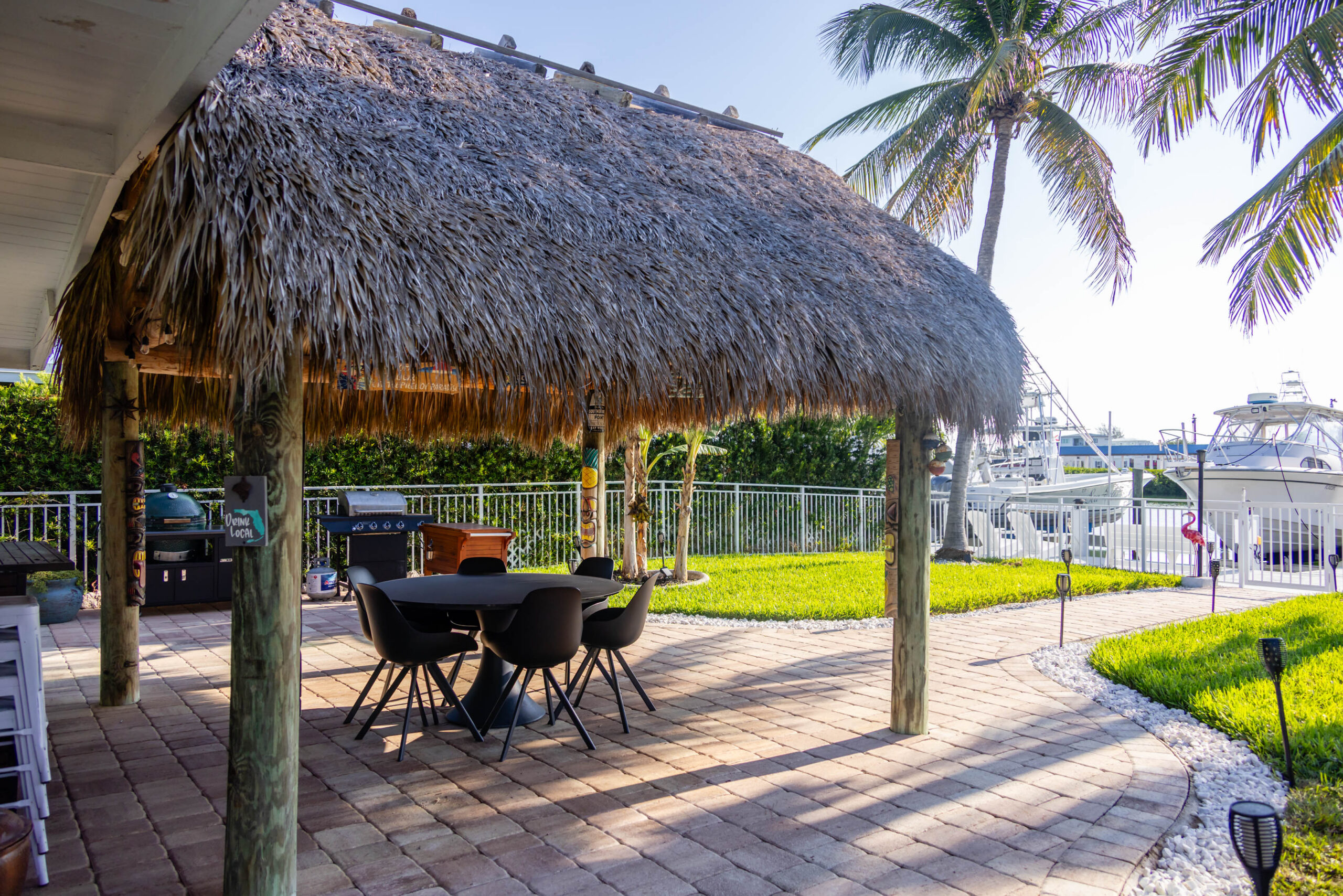 Tiki hut patio overlooking marina and palm trees
