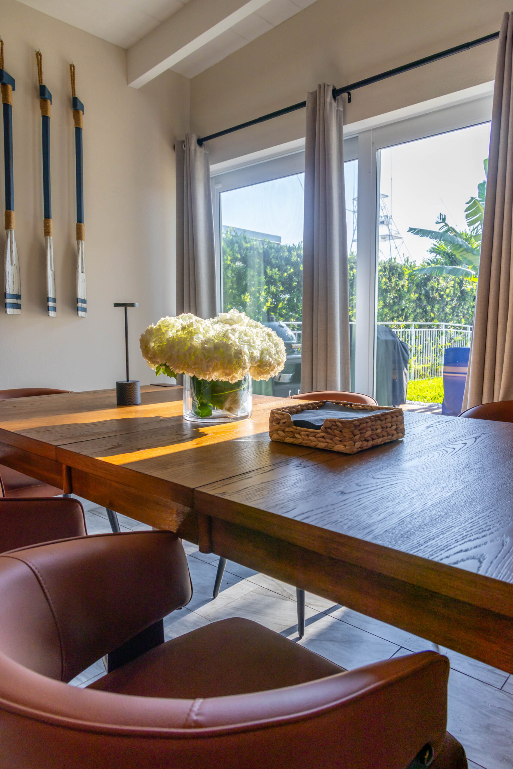 Wooden dining table with white hydrangea centerpiece