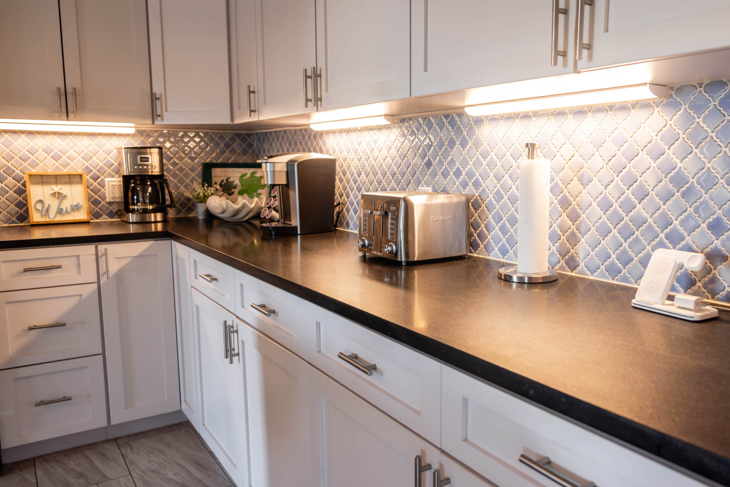 Kitchen counter with coffee maker, toaster, blue backsplash