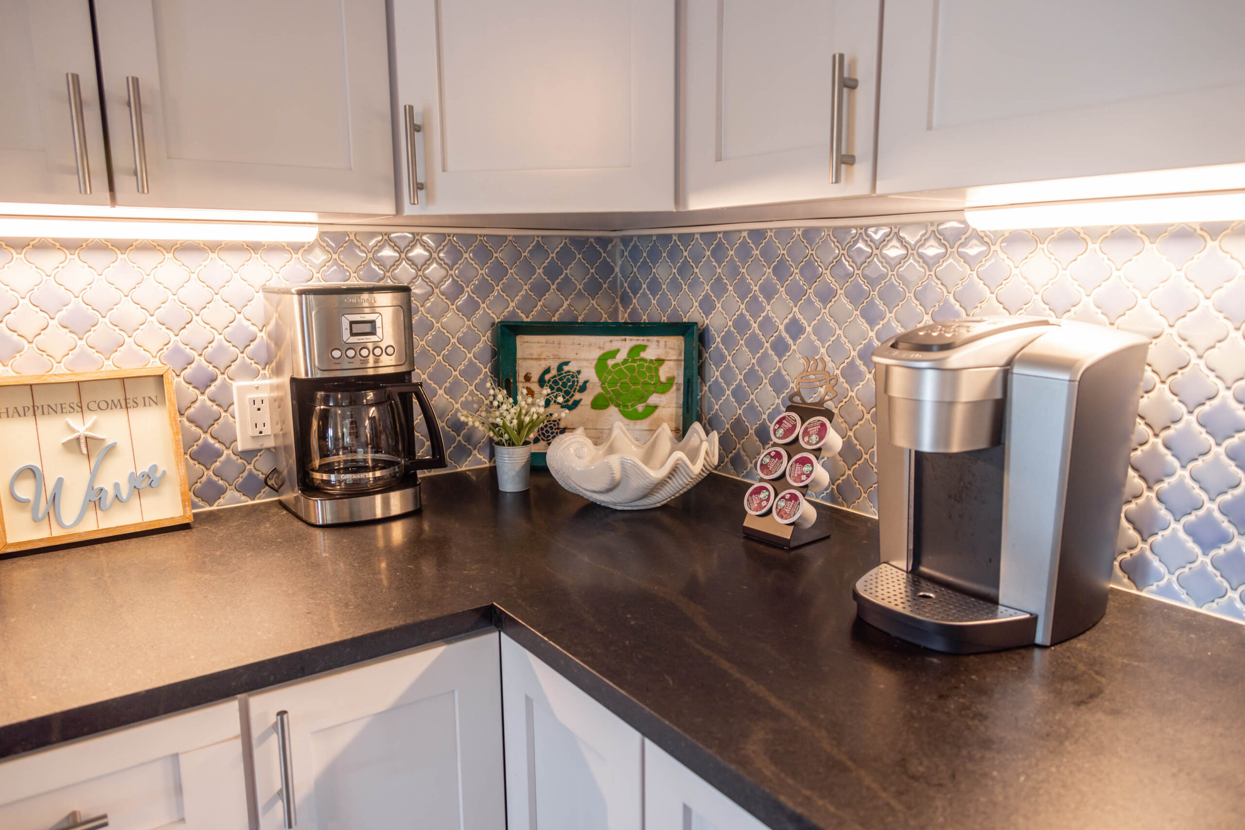 Kitchen countertop with two coffee makers and pods