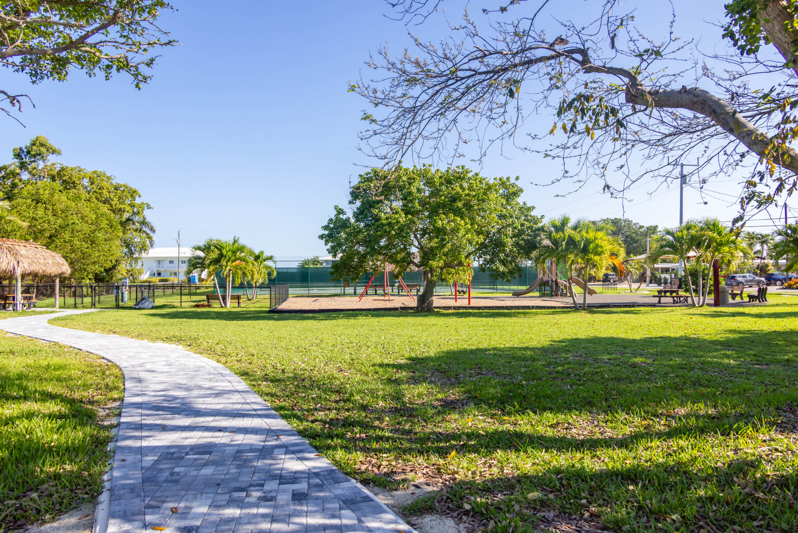 Park pathway leading to playground and trees