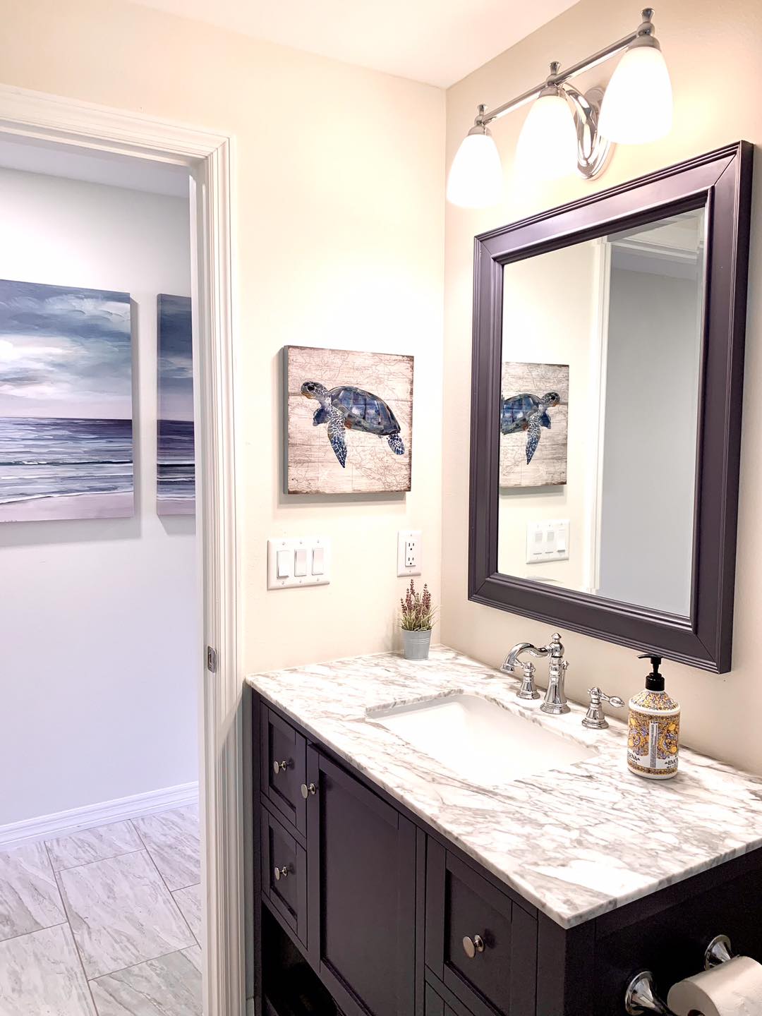 Bathroom vanity with sea turtle wall art