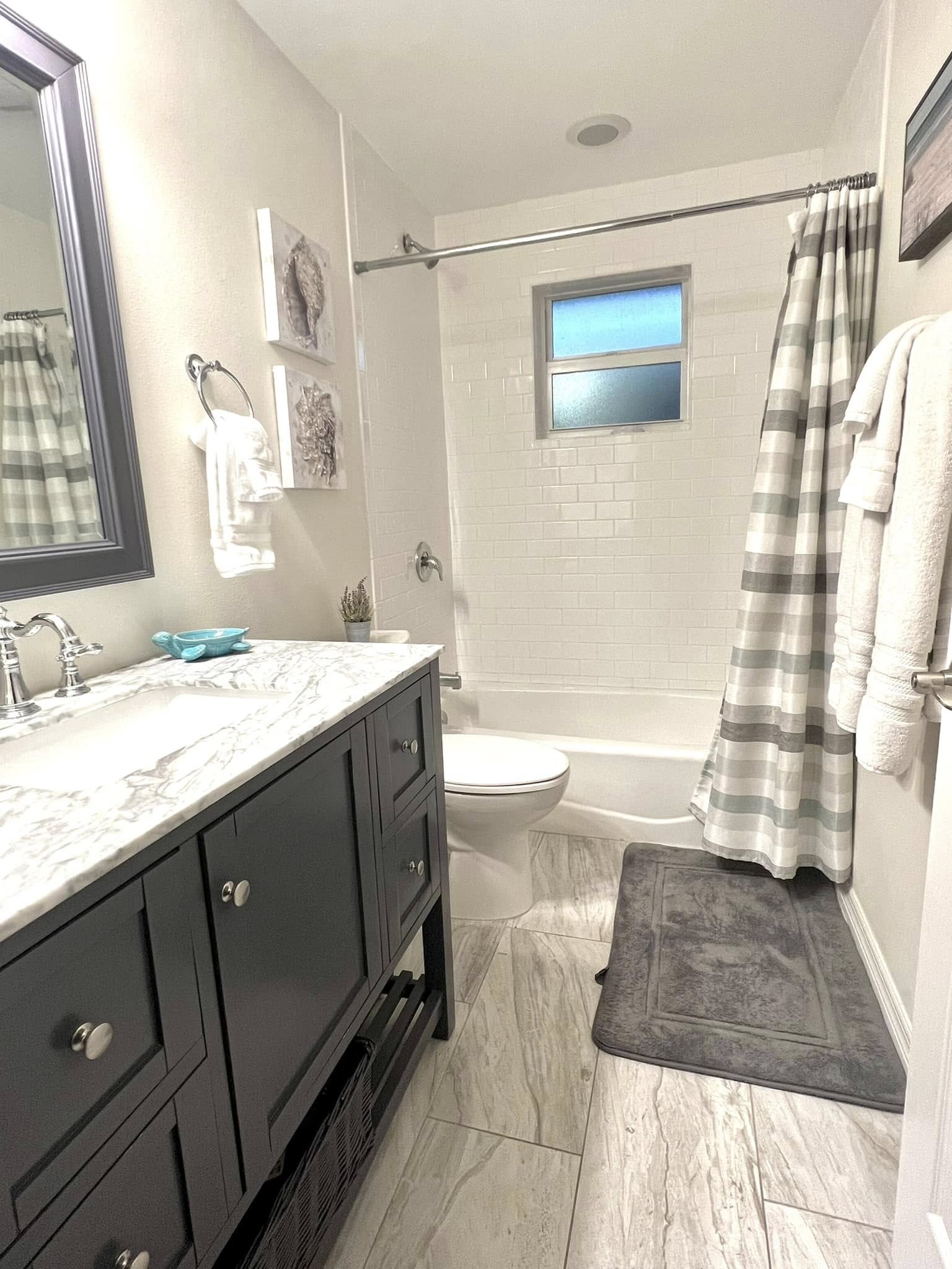 Small modern bathroom with vanity and tub