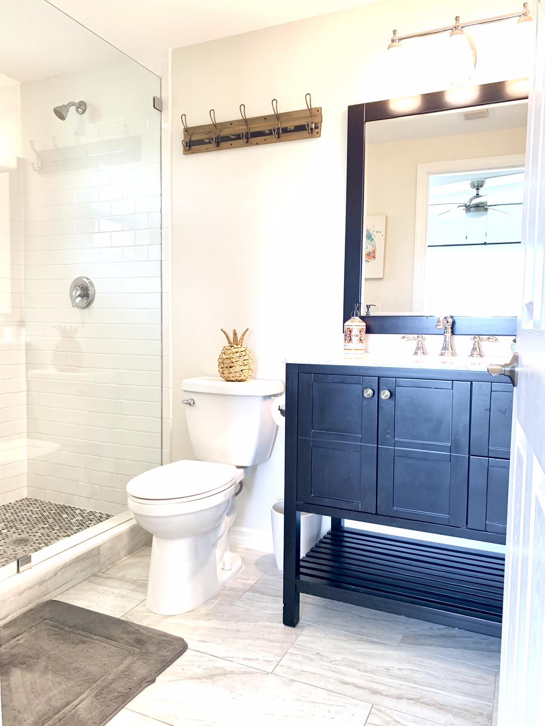 Bright bathroom with black vanity and toilet