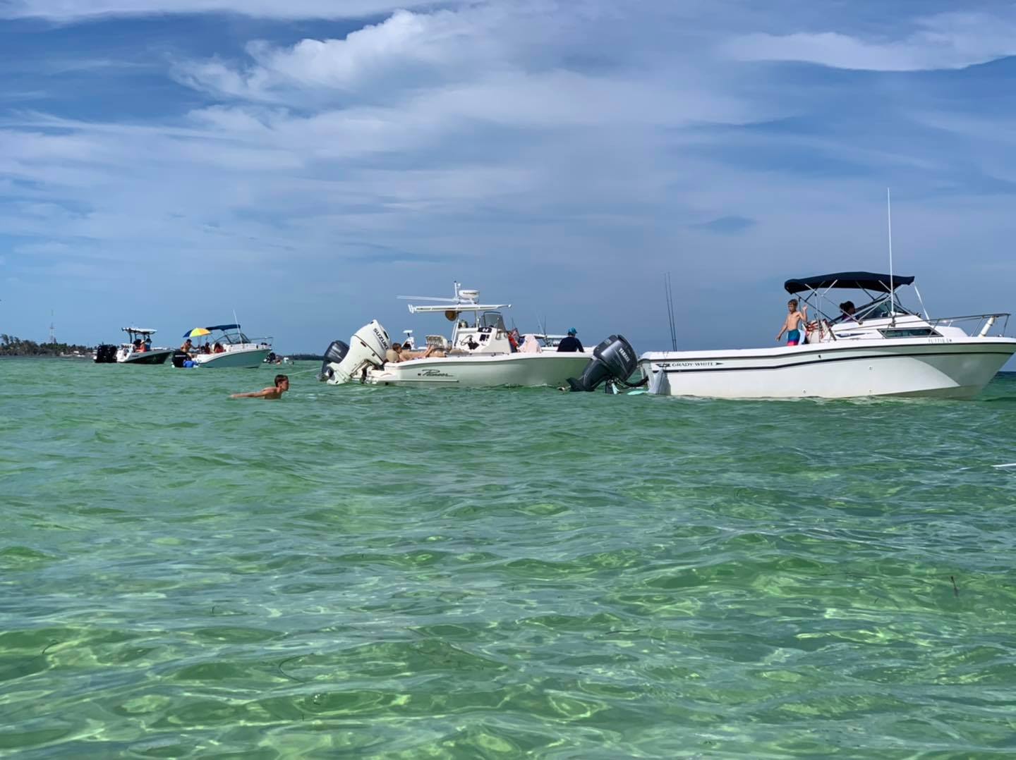 Motorboats anchored in shallow turquoise coastal water