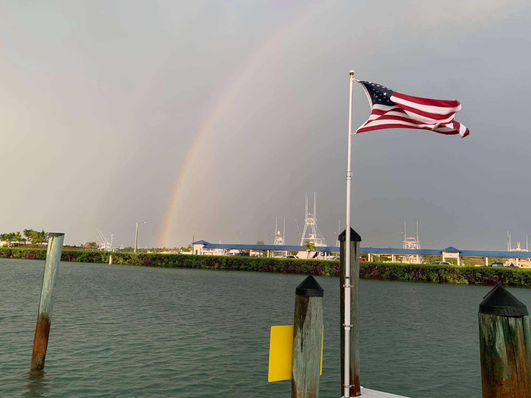 American flag at marina with rainbow
