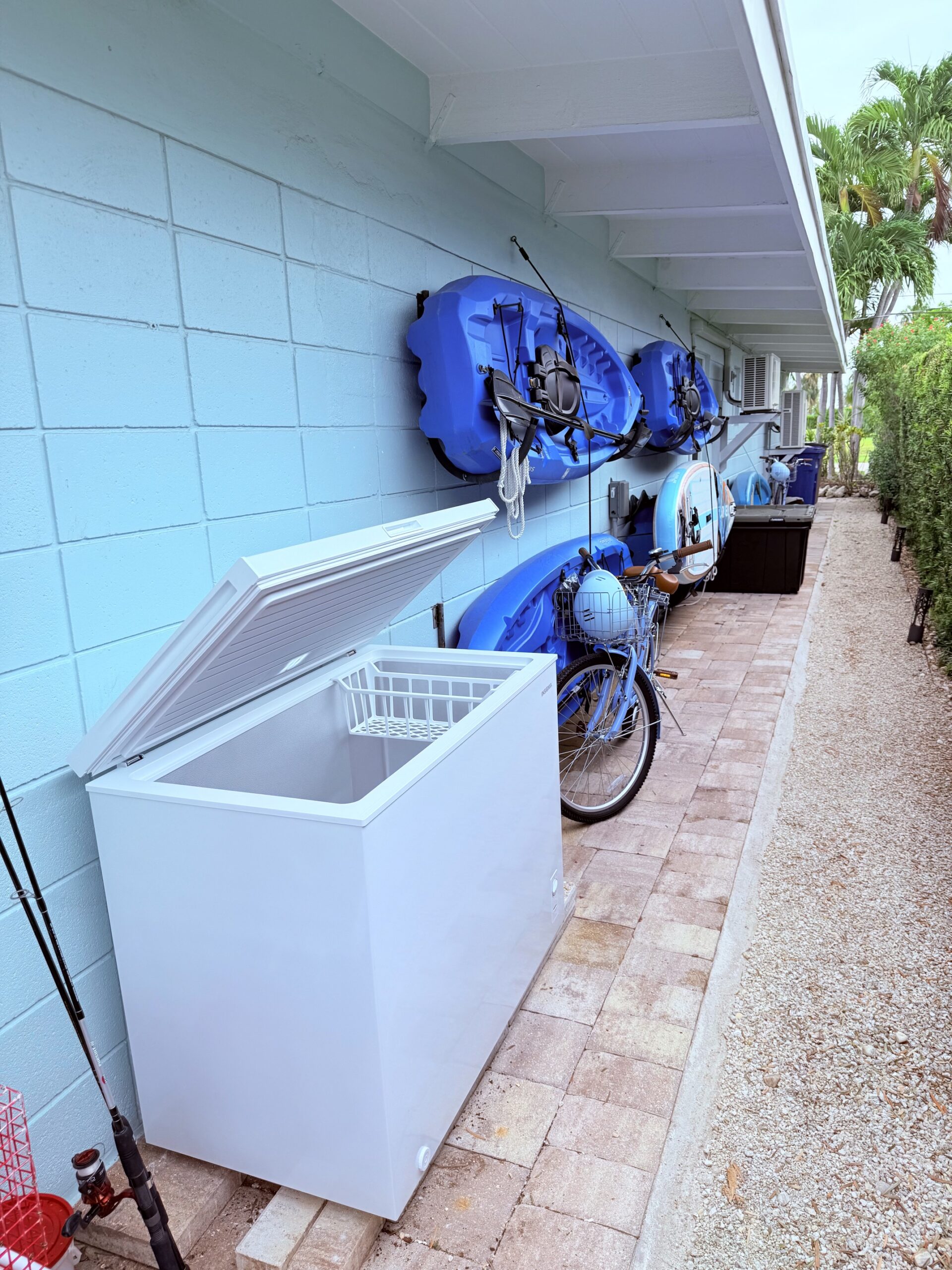 Hanging blue kayaks, bicycles, and freezer