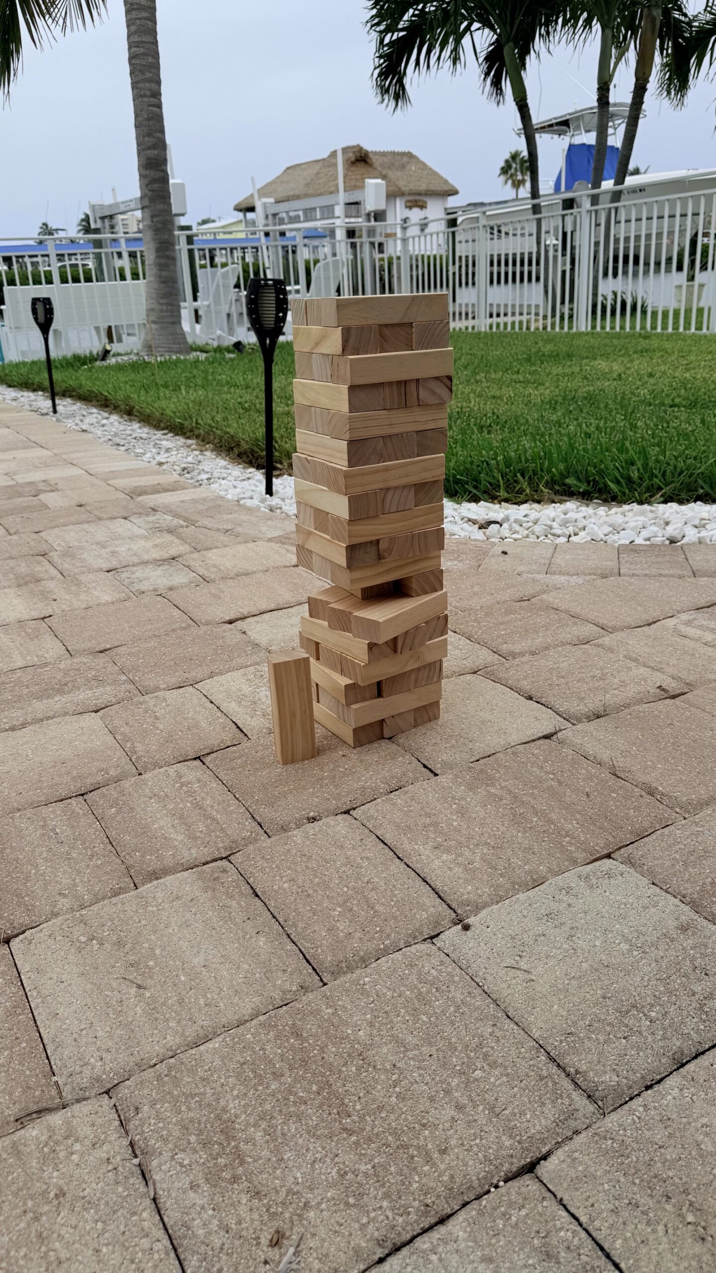Outdoor Jenga tower on tiled patio