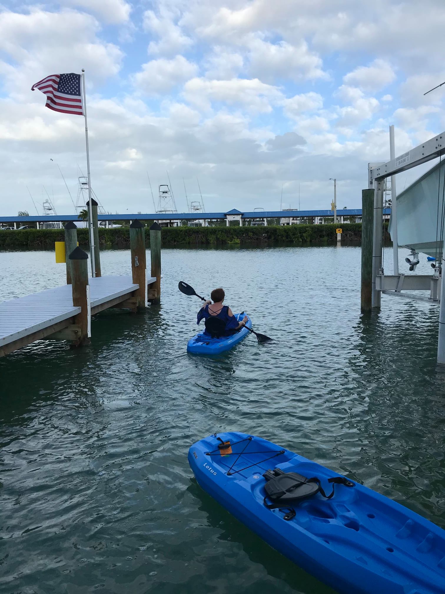 Kayaker near dock with American flag