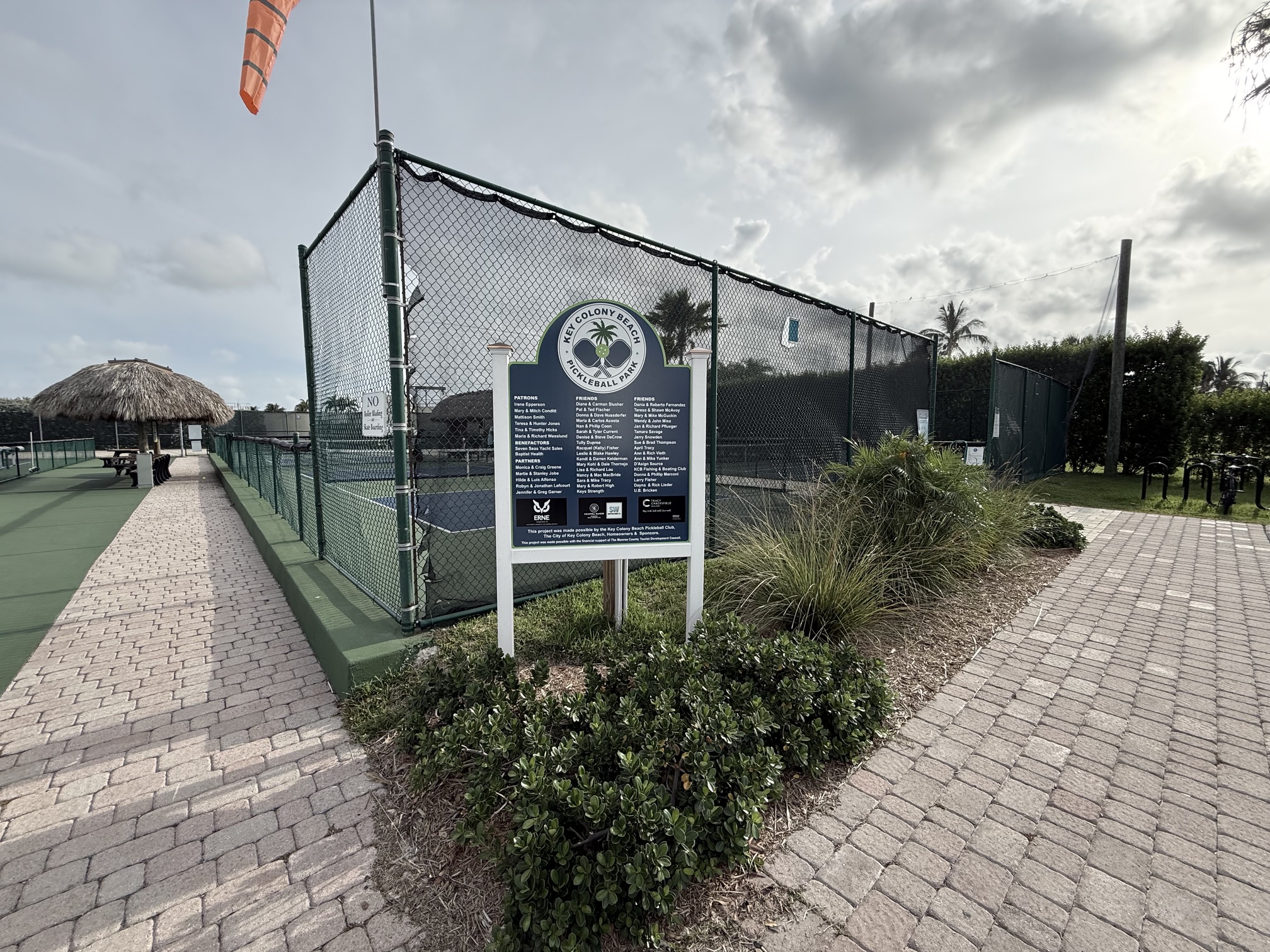 Outdoor tennis courts with informational rules sign