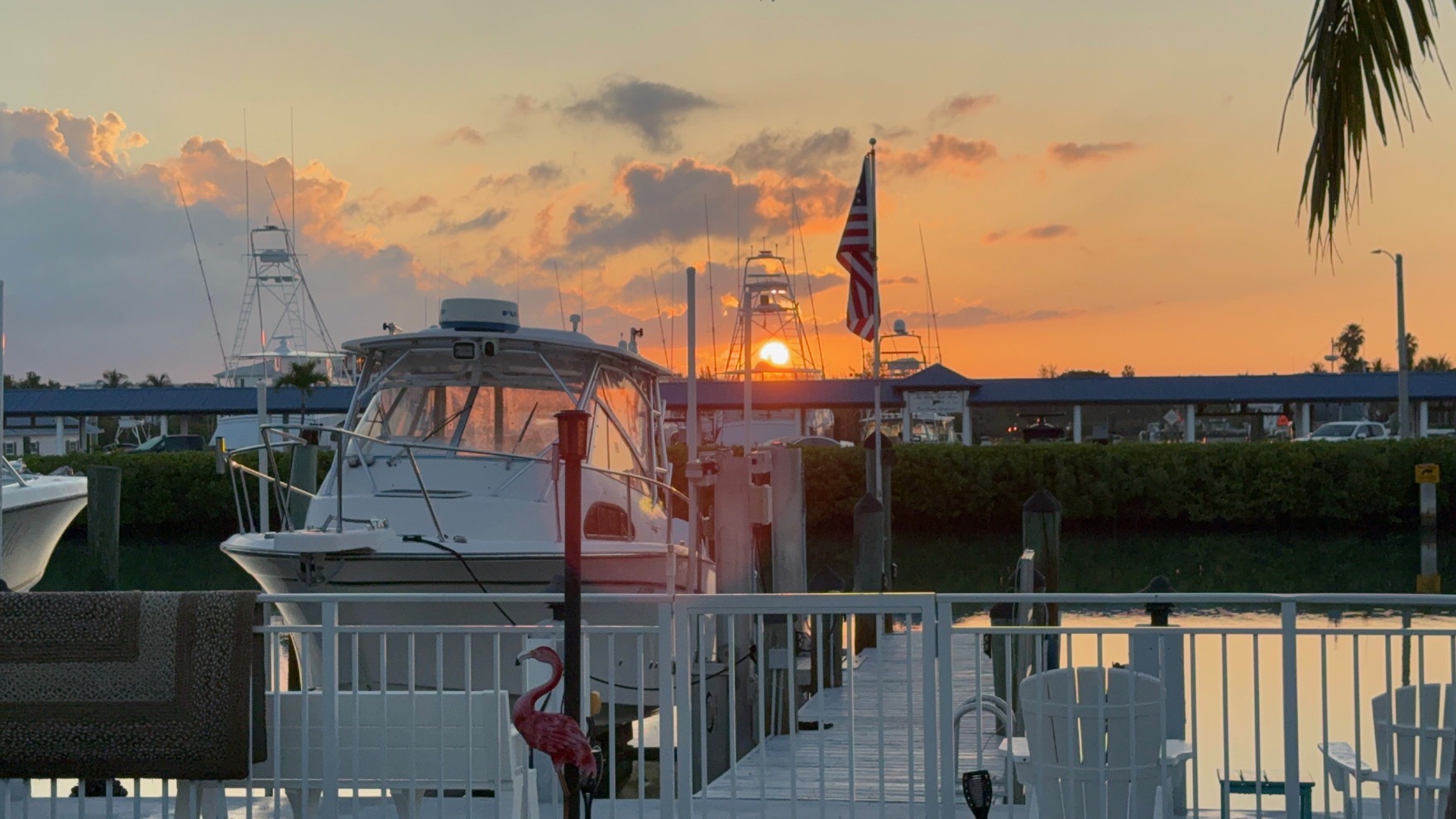 Sunset over marina with boats and dock